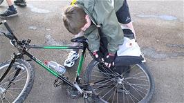 Joe attaches his panniers to his bike on Taunton station